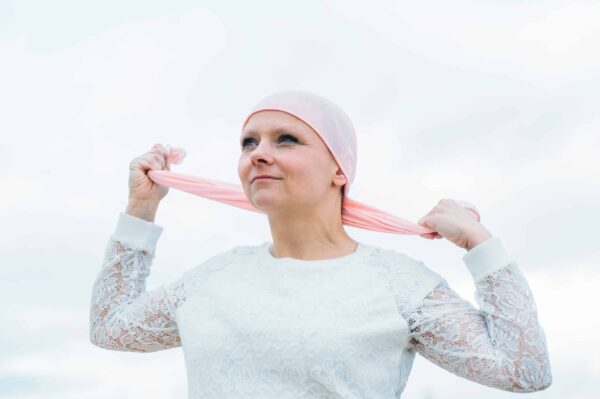 woman with pink headscarf, has cancer breast cancer